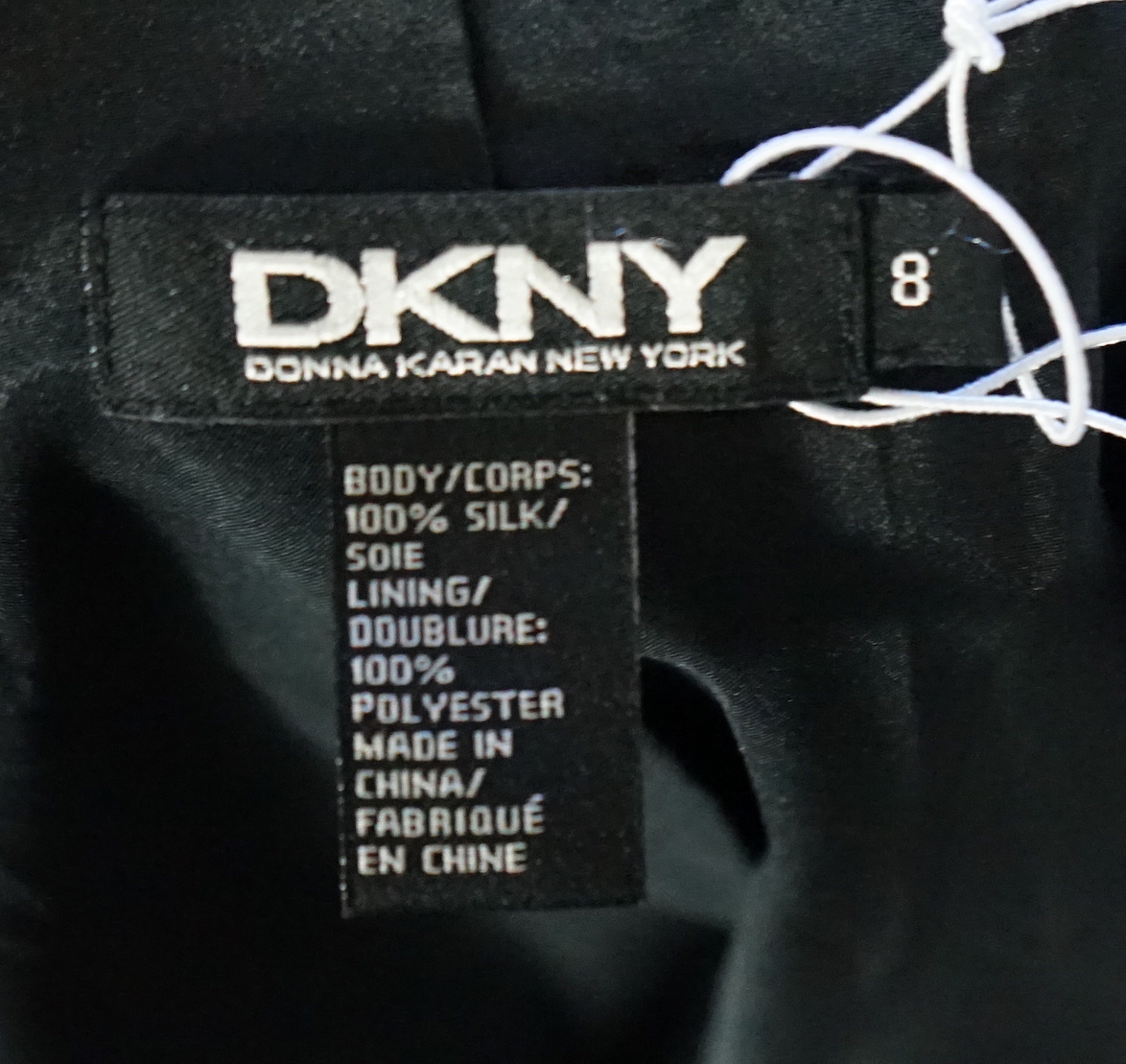 A DKNY red lady's coat and a DKNY satin jacket, coat size 6, jacket size 8